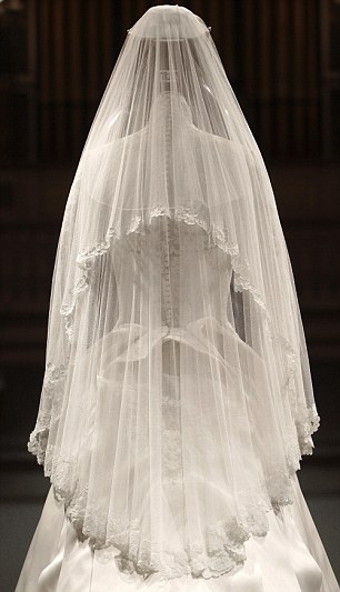 EMBARGOED UNTIL GMT 2301 July 21, 2011. The wedding dress of Britain's Catherine, Duchess of Cambridge is seen as it is prepared for display at Buckingham Palace in London July 20, 2011. Buckingham Palace expects record crowds this summer as up to 650,000 people are set to file into Queen Elizabeth's London residence and past the dress worn by Kate Middleton at her royal wedding to Prince William. The ivory and white garment, designed by Sarah Burton for Alexander McQueen, won over the fashion press and public when Middleton, now the Duchess of Cambridge and a future queen, walked up the aisle of Westminster Abbey in April. Picture taken July 20, 2011. REUTERS/Lewis Whyld/Pool (BRITAIN - Tags: ROYALS TRAVEL SOCIETY ENTERTAINMENT) TEMPLATE OUT